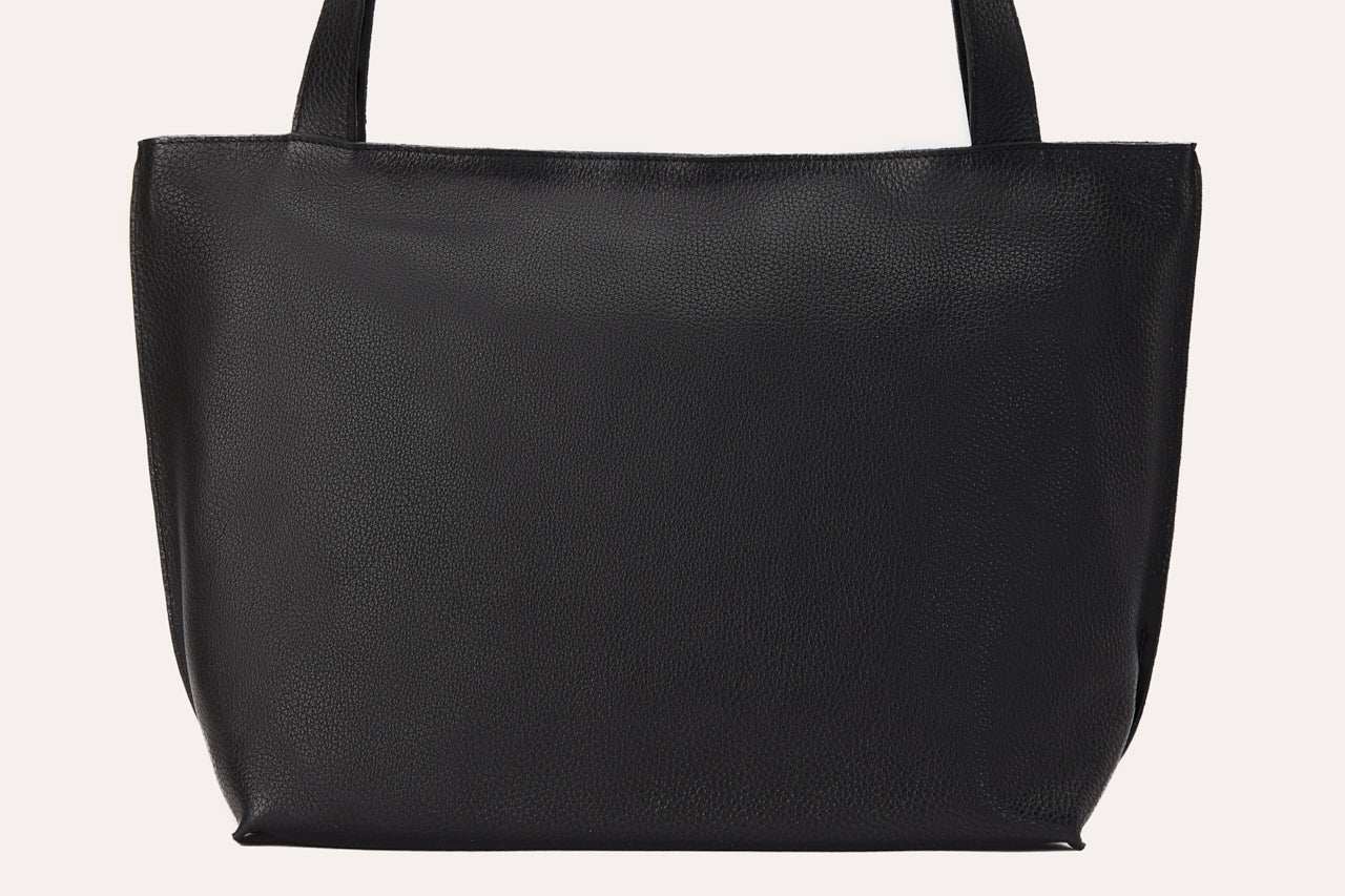 Genuine leather On The Go Tote with top zip closure and interior pockets.